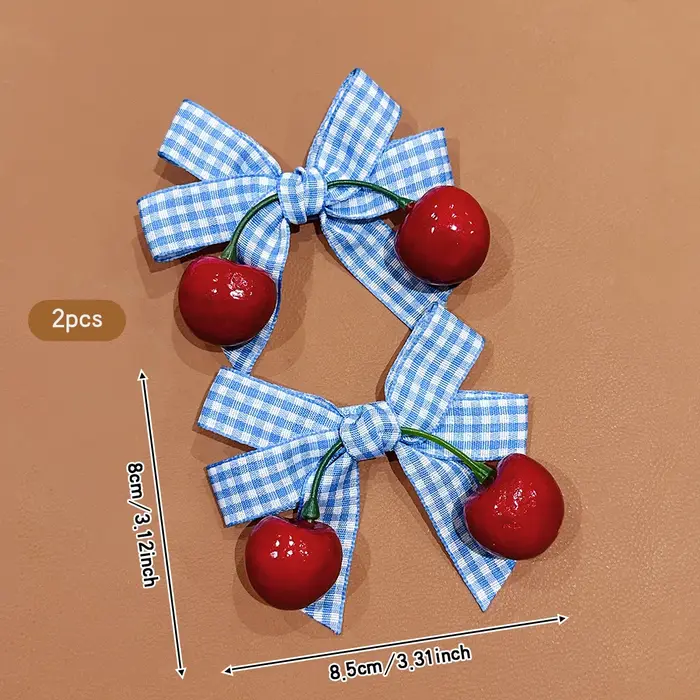 2 pinces à cheveux cerise avec nœud bleu